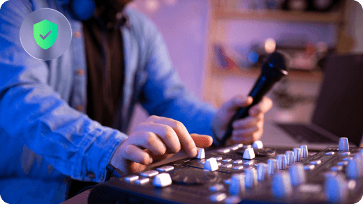 A music producer using a mixing console in a studio